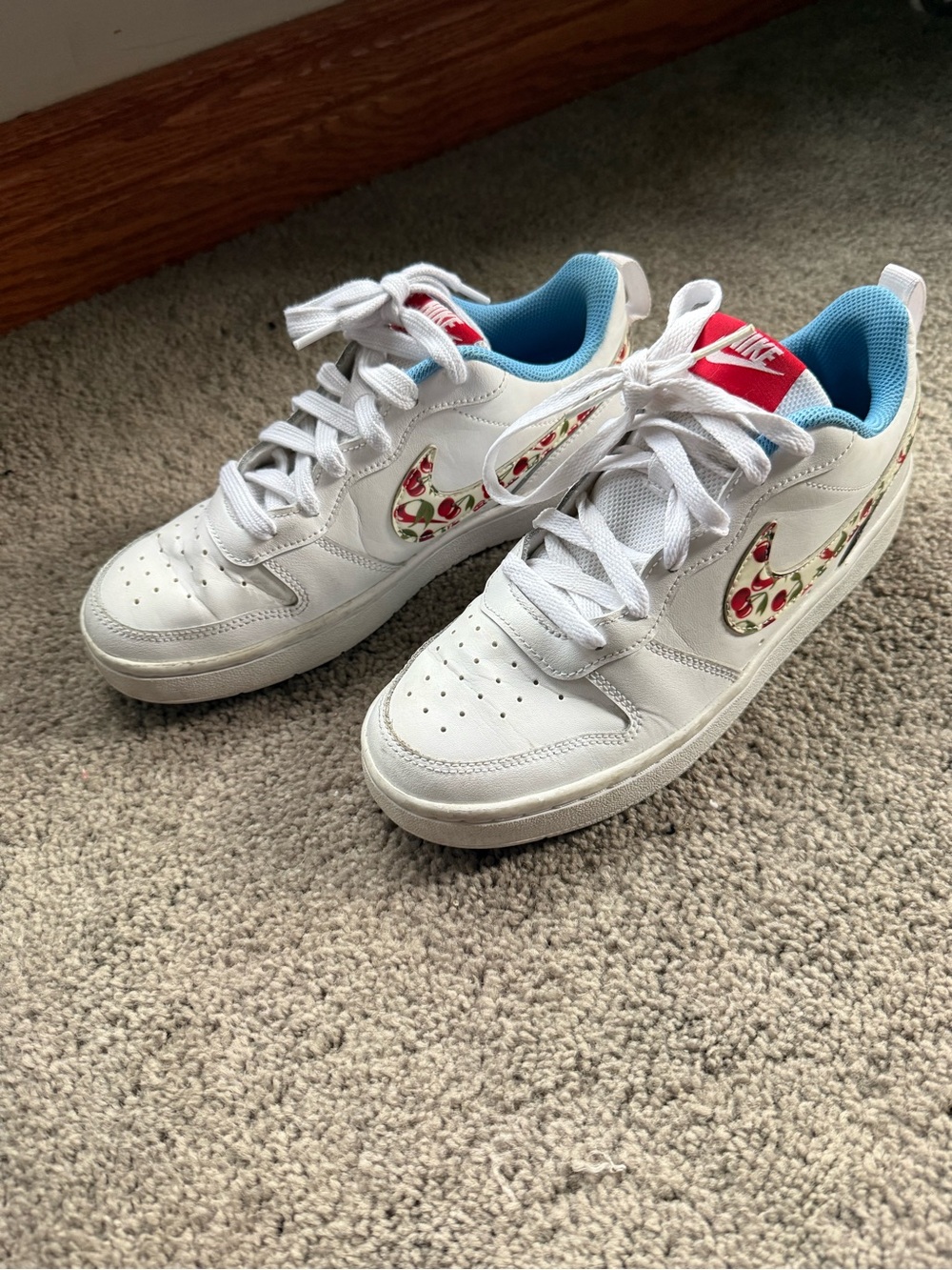 Nike Kids White Sneakers with Cherry Swoosh and Red Tongue Tab